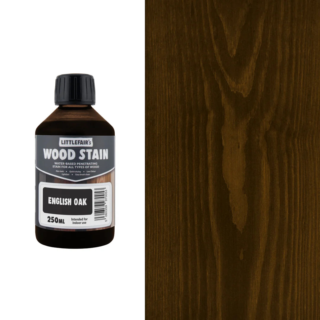Bottle of Littlefain's Wood Stain with English Oak finish next to a wood panel.
