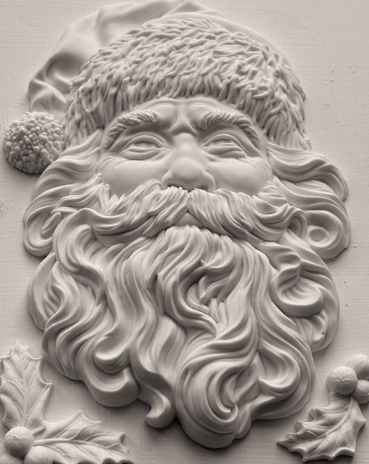Close-up of a decorative relief of Santa Claus with a beard and hat.
