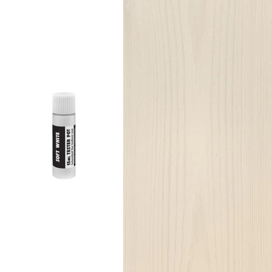 Small white bottle with a black label on a textured beige background