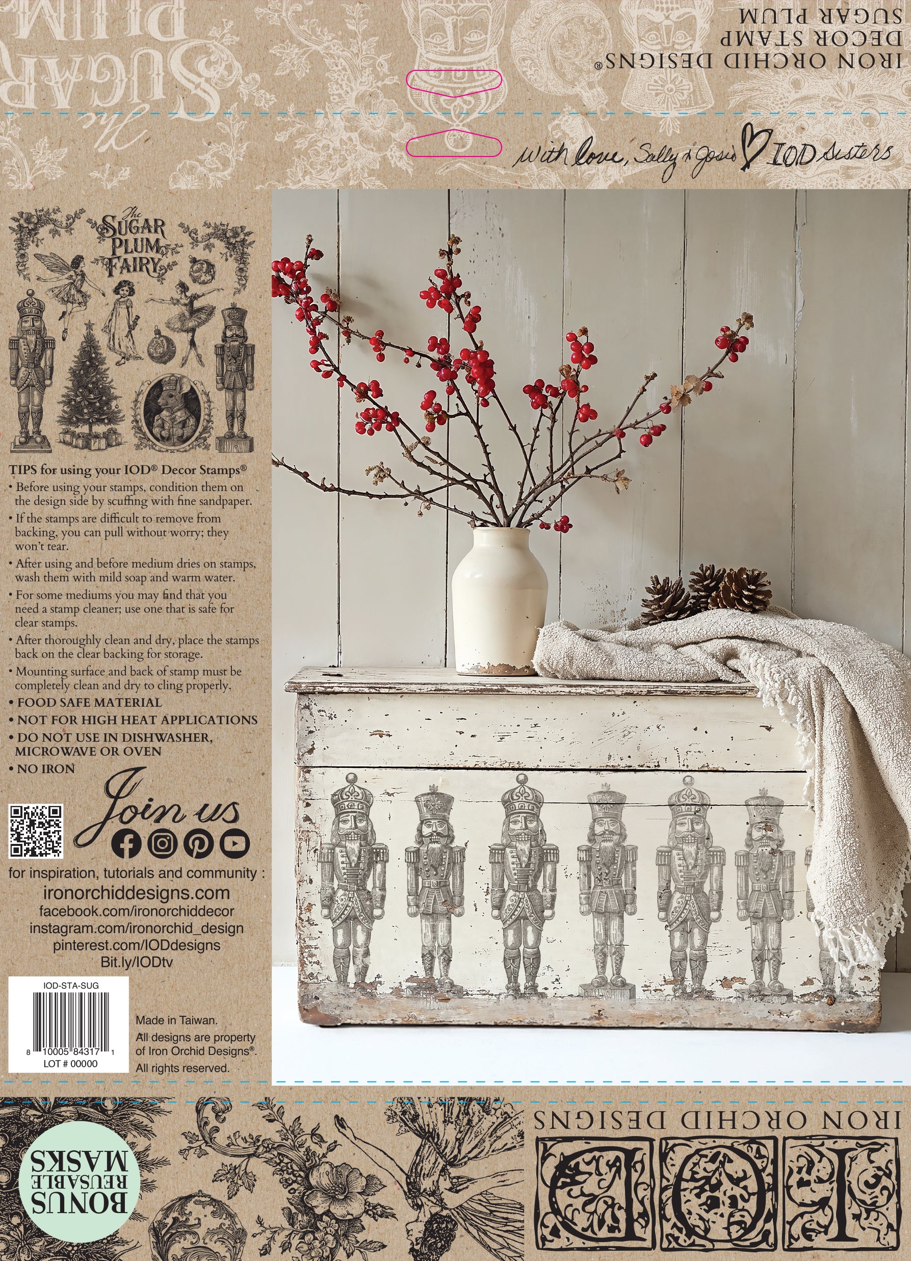 The back cover of IOD Stamp Sugar Plum featuring decorative chest with Nutcracker design, white vase with red flowers, and wooden wall background.