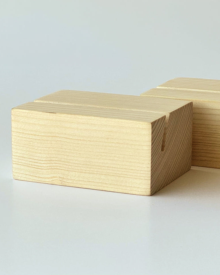 Two rectangular light wood blocks with visible grain and small notches on the sides, photographed on a clean white studio background.