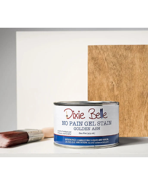 Can of Dixie Belle No Pain Gel Stain with a sample swatch on wood and a brush.