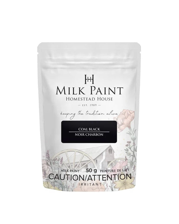 A 50g stand-up pouch of Milk Paint Homestead House in the color Coal Black, featuring a white background with floral illustrations and a black color label.