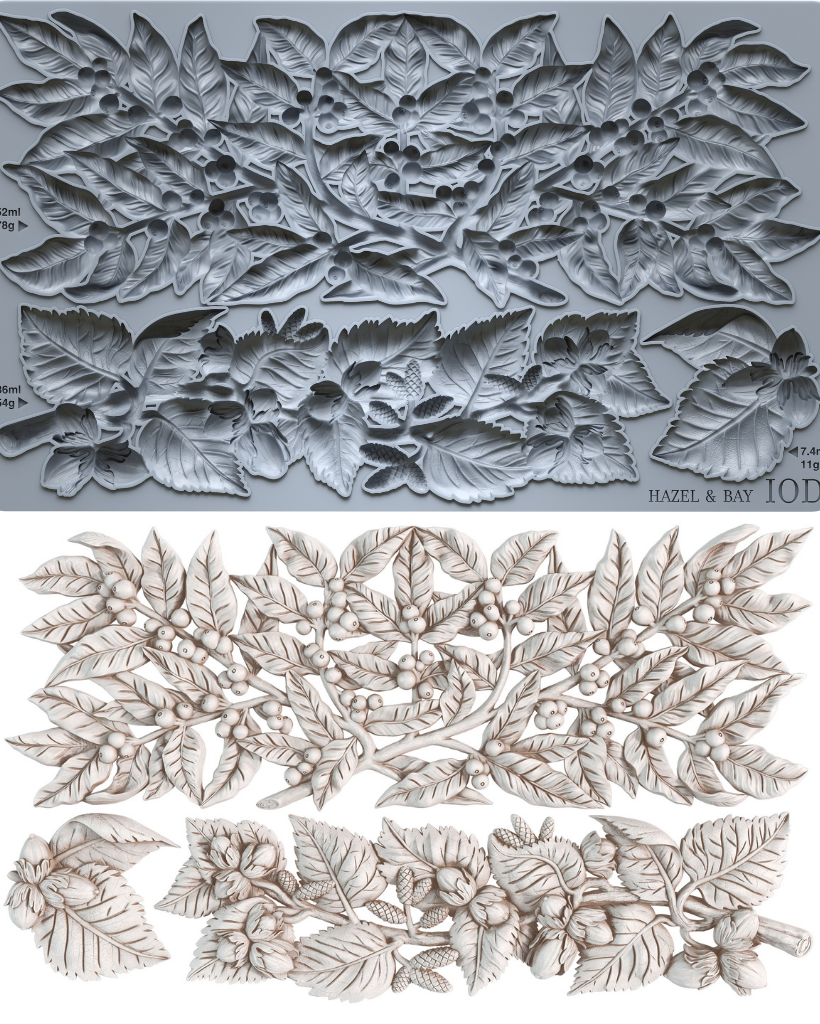 A gray silicone baking or craft mold sheet with embossed floral and leaf patterns, shown above a set of matching light beige carved floral and leaf pieces on a white background. Iron Orchid Designs Hazel and Bay 