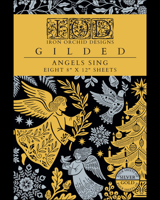 Cover of the Iron Orchid Designs 'Gilded' sheet set, featuring a gold and black background with silver-gray illustrations of angels, a Christmas tree, and snowflakes. Text indicates eight 8" x 12" sheets.