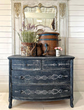 Load image into Gallery viewer, Vintage dresser with decorative elements using IOD Paint Inlay against a wooden wall.