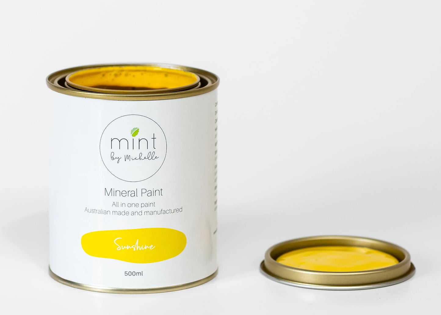 A can of Sunshine Yellow Mineral Paint for furniture by MINT by Michelle with the lid open showing the yellow paint inside.