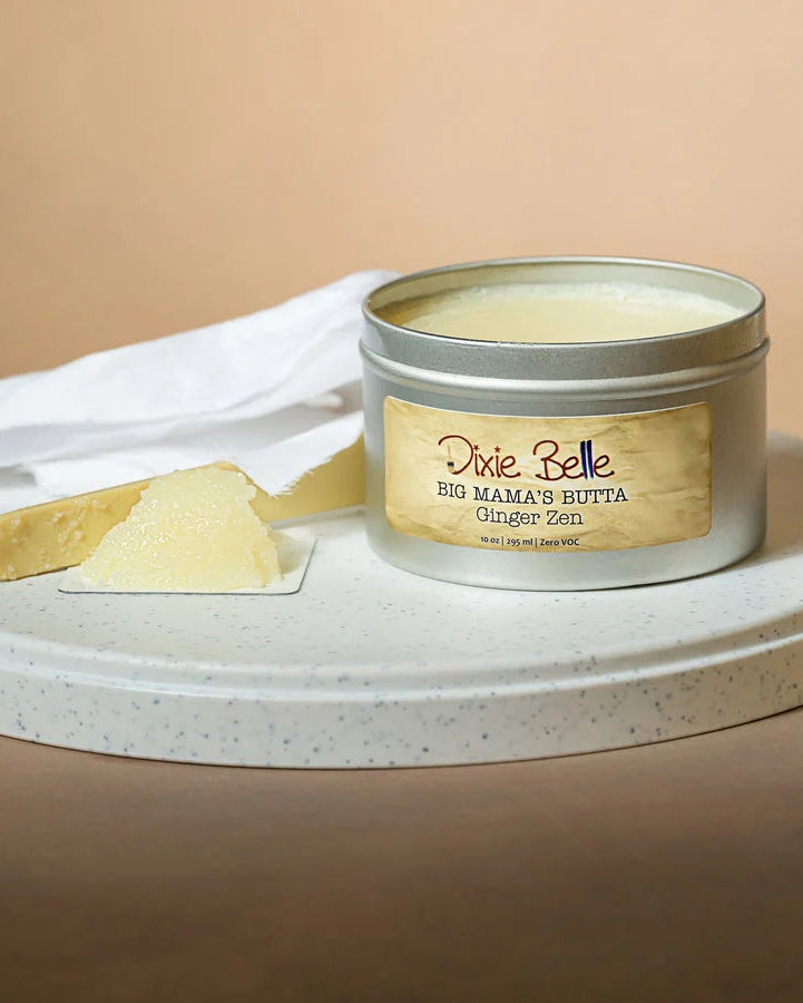 Jar of 'Big Mama's Butta' with a scoop of product on a beige background